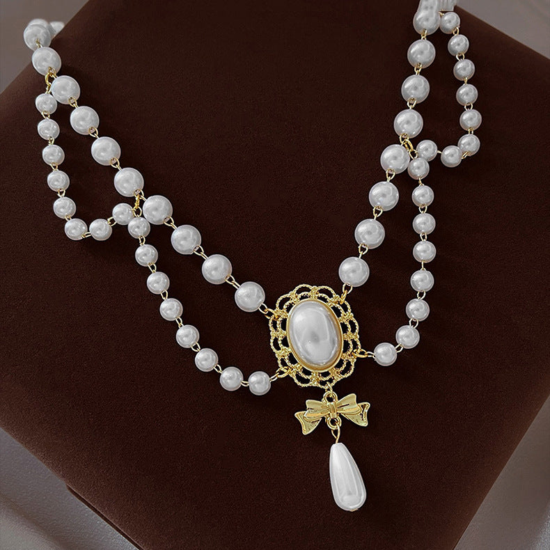 Gilded Bow Pearl Necklace