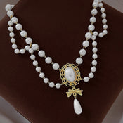 Gilded Bow Pearl Necklace width=100 