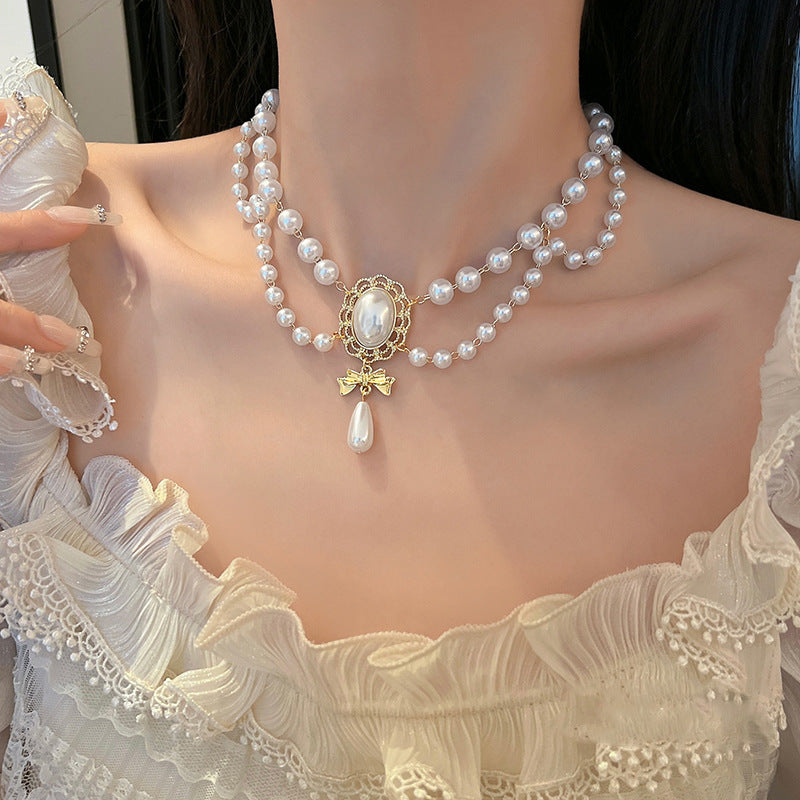 Gilded Bow Pearl Necklace