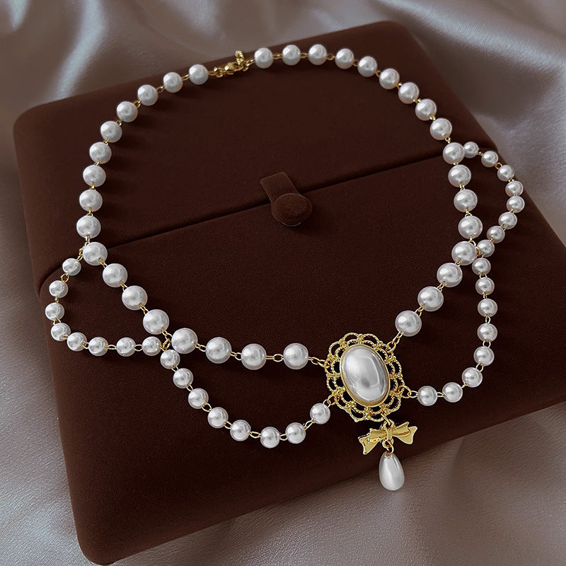 Gilded Bow Pearl Necklace