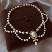 Gilded Bow Pearl Necklace width=100 