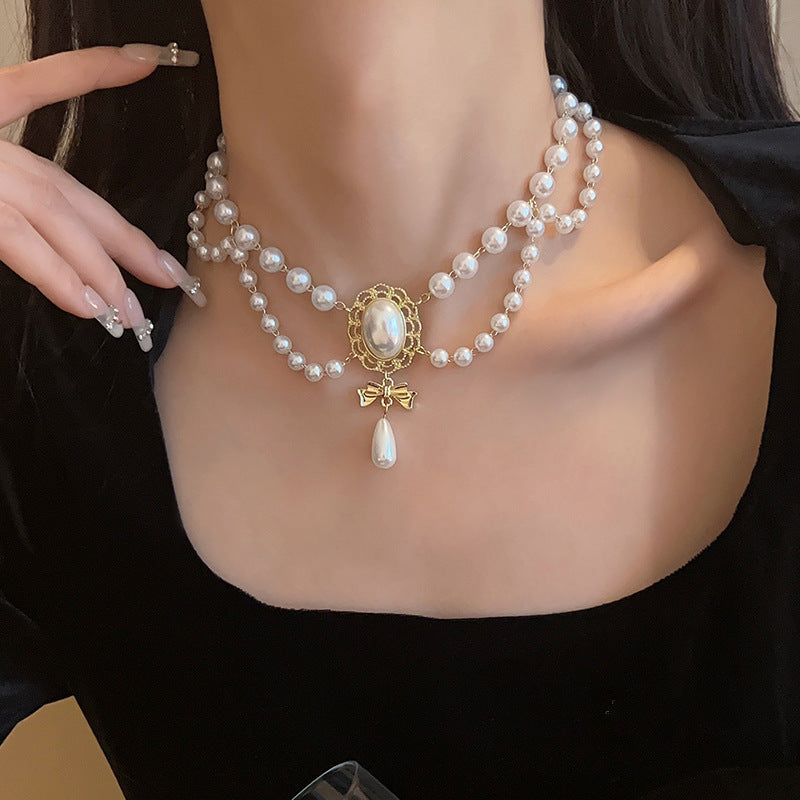 Gilded Bow Pearl Necklace